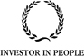 The logo of Investor in People featuring a black laurel wreath placed above the text "Investor in People."