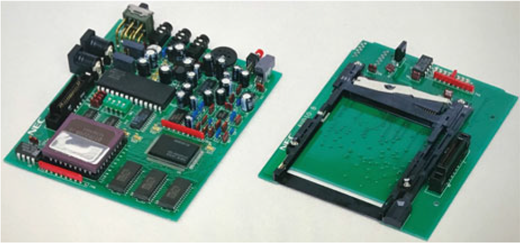 A photograph showing two printed circuit boards with electronic components and an L C D display module.