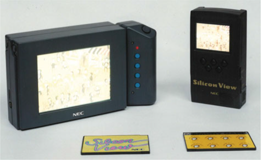 A photograph showing two portable video viewer devices with screens and buttons, along with two small accessory cards.