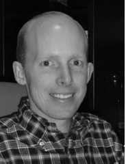 A profile box with a portrait showing the face obscured and text listing Ryan Watkins s title, department, university, street address, telephone number, and website.