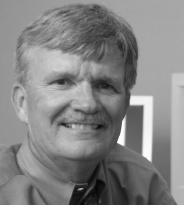 A profile box with an obscured face and text listing Michael Simonson s editorial and faculty roles, university, department, office address, telephone number, and email address.