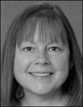 A portrait that presents a woman with shoulder length hair shown above printed academic and contact information.