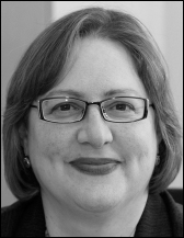 A portrait that presents a woman with short hair and glasses shown above printed academic and contact information.