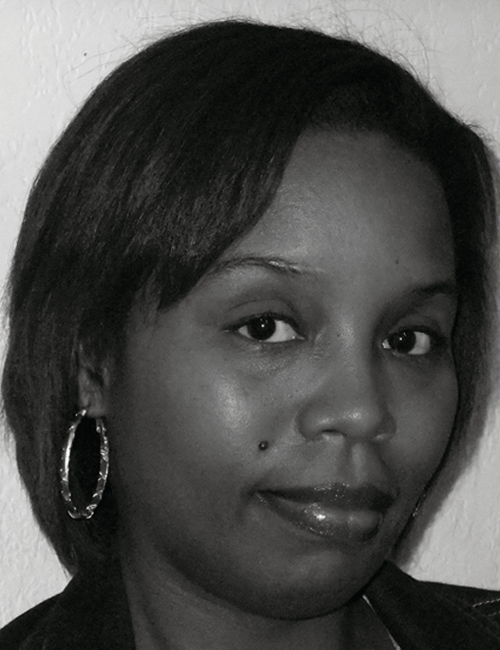 A black and white portrait of a woman with short hair, wearing hoop earrings. She has a calm expression and is looking slightly away from the camera.