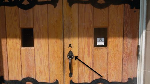 Wooden double doors with handle labeled A and arrow pointing to it, illustrating pull function without a signifier.