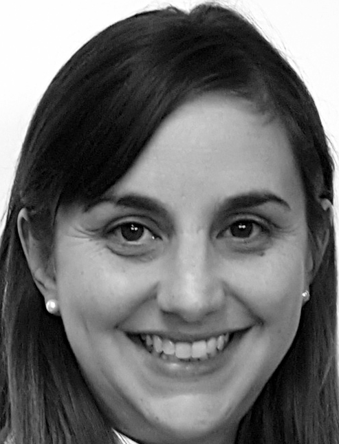 Smiling woman with dark hair and earrings looks forward in a framed headshot. Labelled, Roxanne Molina, Assistant Professor and Assessment Coordinator, Abraham S. Fischler College of Education..