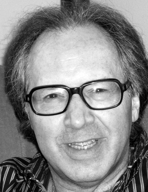 A black and white headshot of Errol Craig Sull wearing glasses and smiling, with his professional contact information listed below.