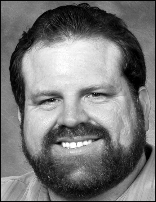 A black and white headshot of a smiling man with a contact card showing role Professor at Seminole State College of Florida.