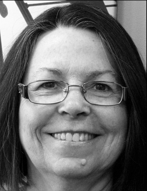 A black and white portrait of Frances Bernat smiling.