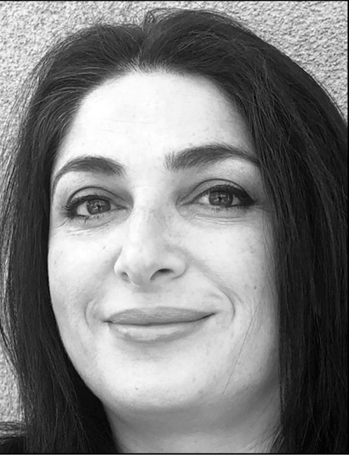 A professional black and white headshot of Wendy Kaaki with her name. A woman smiling and looking to the side.