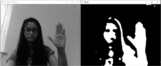 An interface shows two windows, one with a person raising a hand and one with a black and white silhouette of the same person and hand.