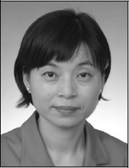 A black and white photo of an Asian woman with short hair, showcasing her features and the timeless quality of the image.