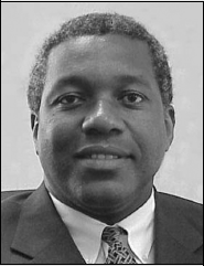A monochrome image of a man dressed in a suit and tie, exuding professionalism and elegance.