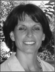 A monochrome photograph of a woman smiling, reflecting a sense of joy and positivity.