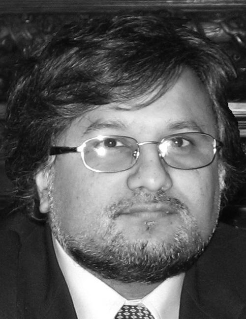 A portrait of Nish Sonwalkar with text identifying him as Vice President and Associate Dean at Cambridge College and Chairman of I D L Systems, with a Boston, M A address.