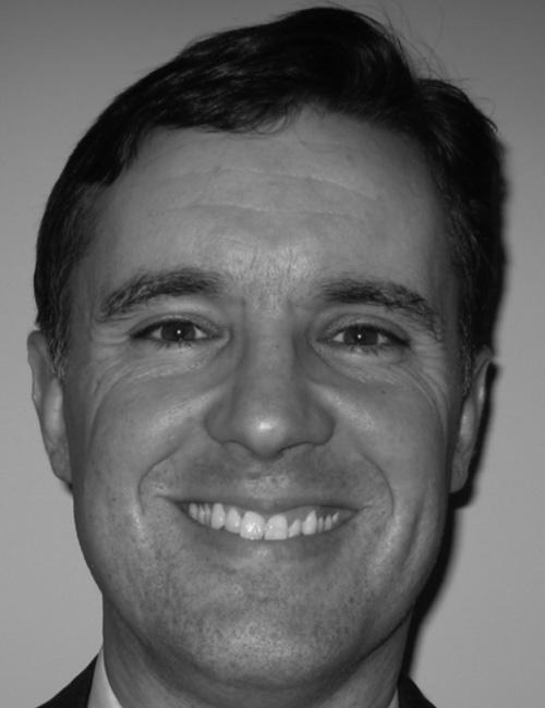 A grayscale portrait of a man above printed text listing his name, job title, company affiliation, mailing address, telephone number, and email.