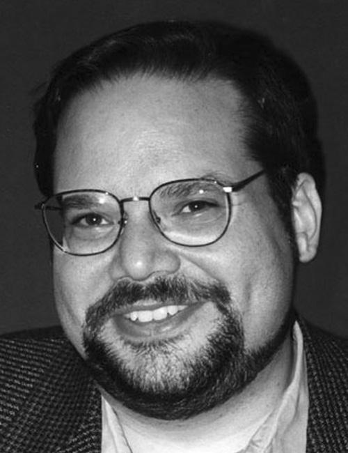 A portrait of a man above a text box listing a professional contact with name, title, organization, address, telephone number, and email.