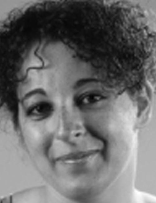 Black and white photo of Silvia Micarelli, woman with curly hair smiling, with text listing her address in L'Aquila, Italy, phone number, and email contact.