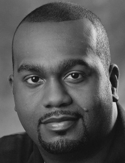 Black and white photo of a man above a text block listing his academic director roles, programs in digital media, school address, phone number, and email.