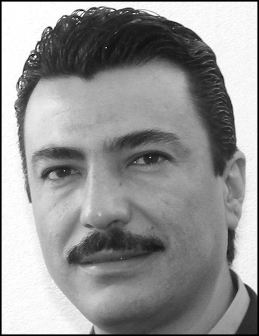 A portrait of an adult man with short hair and a mustache appears above a centered block of printed professional information containing his academic title, institutional affiliation, address, telephone number, and email.