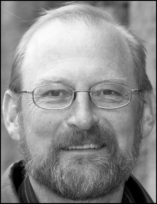 A grayscale head-and-shoulders portrait of an adult person above a block of professional information that includes an academic role, department affiliation, address, telephone number, and email.
