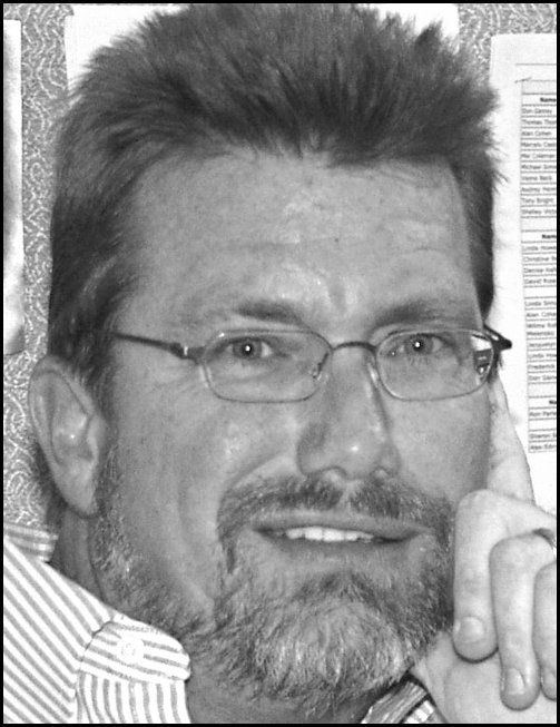 A grayscale head-and-shoulders portrait of an adult person above a block of professional information listing an academic role, university affiliation, mailing address, telephone number, and email, all within a thin rectangular border.