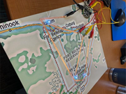 A map of the Fort Belknap Reservation carries a copper tape circuit with L E D lights and connected alligator clips and a microcontroller. The copper tape circuit and LEDs symbolize food access on the Fort Belknap Reservation.