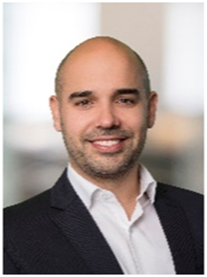 A photograph of Nikolaus Obwegeser, a bald middle-aged man in a suit, looking at the camera with a slight smile.