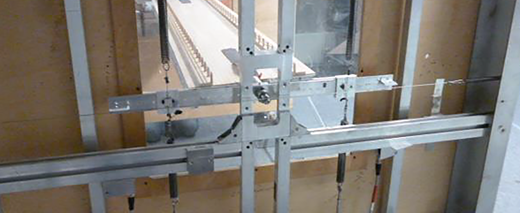 An experimental bridge deck apparatus mounted within a structural testing frame.