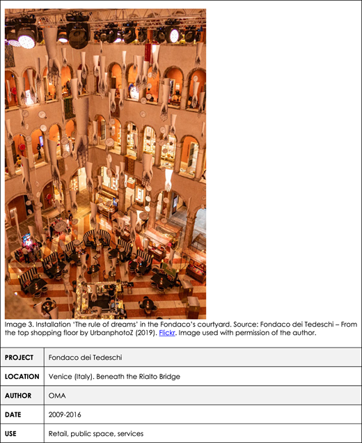 A table with a photo shows a vibrant interior of Fondaco dei Tedeschi with hanging art installations.