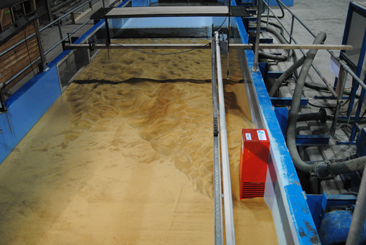 A laboratory view shows a flume with a sand bed and a Test 1 block during a hydraulic experiment.