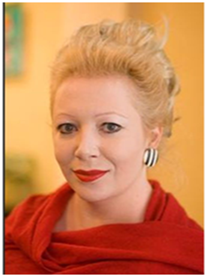 Portrait of a woman with blonde hair styled in an updo, wearing red lipstick and a red top.
