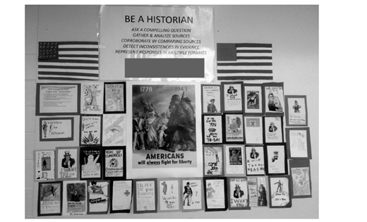 A classroom bulletin board titled Be a historian displays instructional steps and historical posters including slogans like i want you, buy war bonds, and Americans will always fight for liberty.