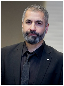 A photograph of Ramin Karim looking at the camera with a neutral expression.