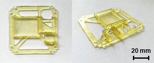 A 2-view photograph of a small square component, with a scale bar labelled 20 millimetres.
